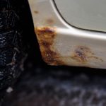A little rust at the bottom of the car sill. Paint bloat. High quality photo